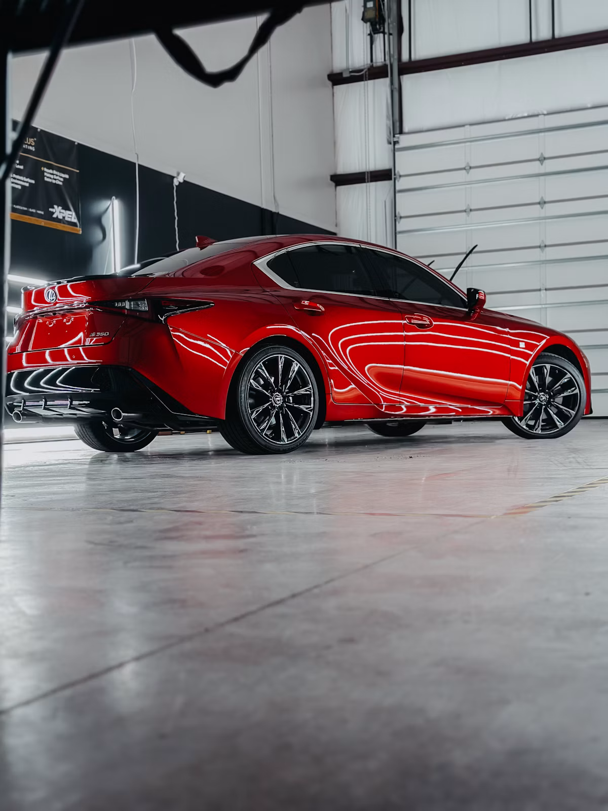 Freshly detailed red sedan in the studio